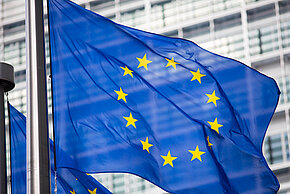 Eu,Flag,In,Front,Of,Berlaymont,Building,Facade