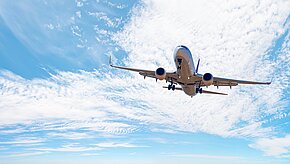 White,Passenger,Airplane,Flying,In,The,Sky,Amazing,Clouds,In