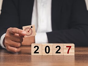 Business,Planning,And,Strategy,In,2027.,Hand,Businessman,Holding,Wooden